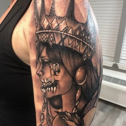 Black and grey neo-traditional dead queen with a crown tattoo on the upper arm