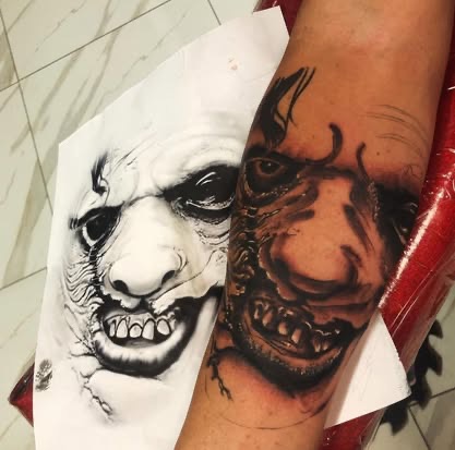 Black and grey realism demon monster face tattoo on the forearm from a reference photo