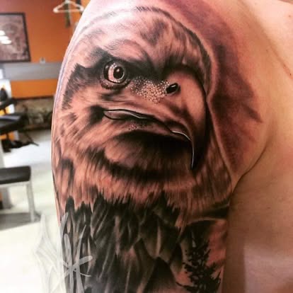 Black and grey realism eagle head tattoo on the shoulder