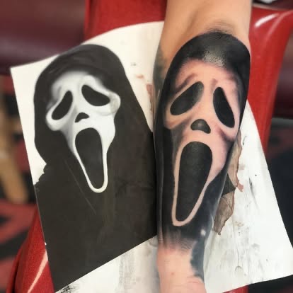 Black and grey realism Ghostface Scream mask tattoo on the forearm