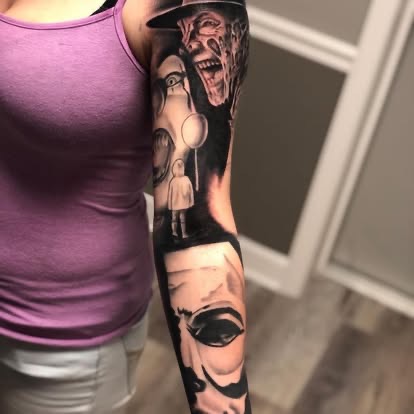 Black and grey horror sleeve tattoo featuring Freddy Krueger and Pennywise