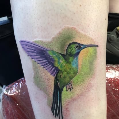 Color realism green hummingbird tattoo on the forearm