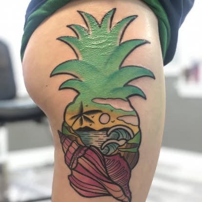 Color new-school pineapple with a beach sunset scene and seashell tattoo on the thigh