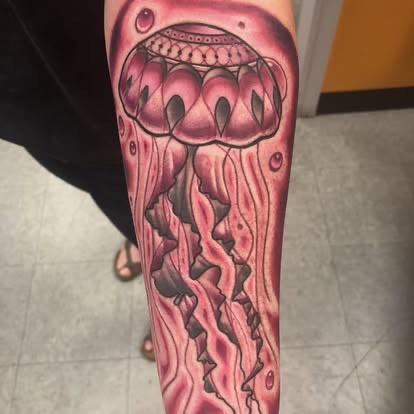 Neo-traditional pink jellyfish tattoo on the forearm by Scout at Until Ink Do Us Part