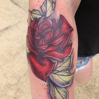 Neo-traditional color red rose tattoo with green leaves on the leg, by Until Ink Do Us Part in Wausau, WI