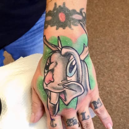 Color new-school cartoon goat tattoo on the hand