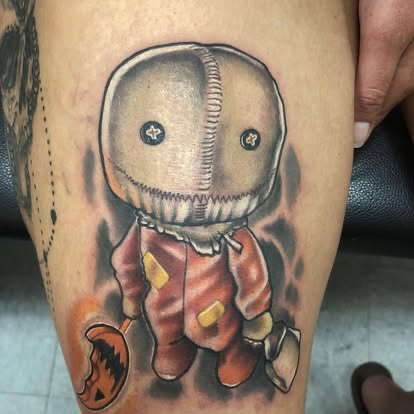 New-school color tattoo of Sam from Trick r Treat with a burlap sack head on the thigh