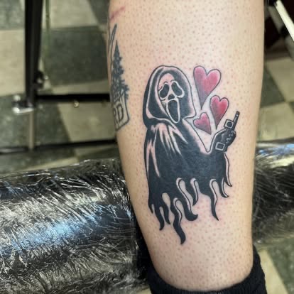 Traditional Ghostface from Scream with red hearts and a bottle tattoo on the lower leg